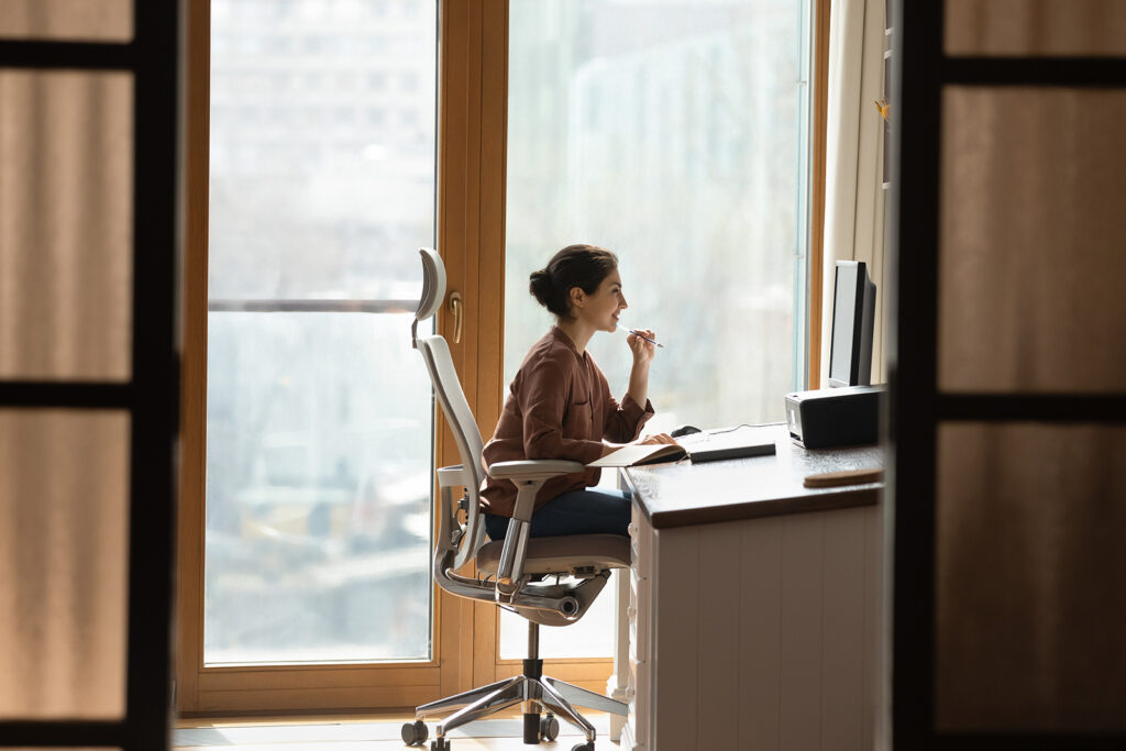 Woman working at her computer at her desk